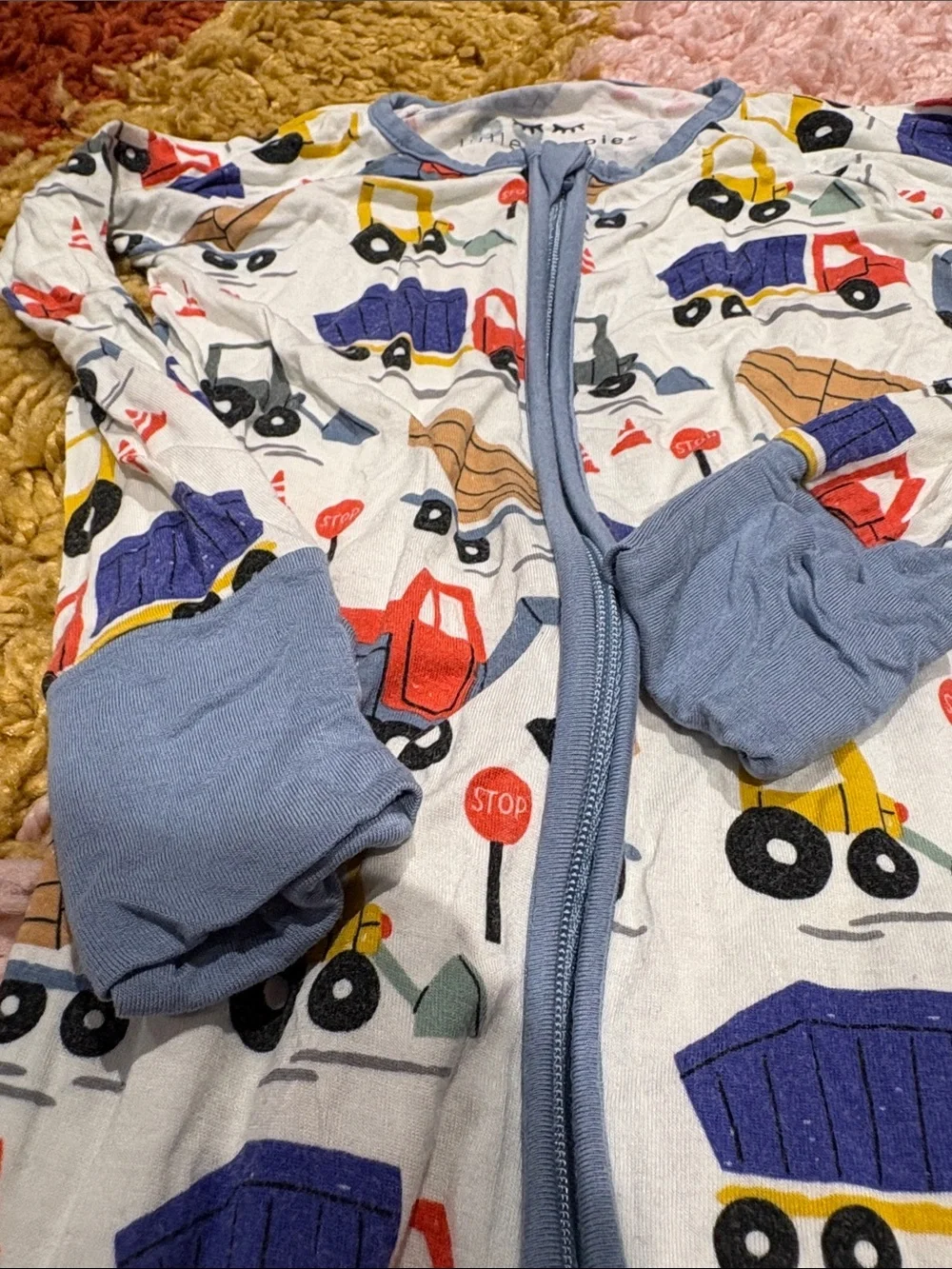 Little Sleepies White One-Piece Footie with Multicolor Truck Print and Blue Trim